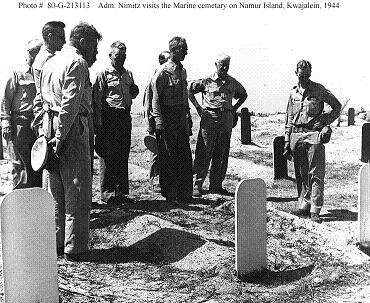 Photograph of Nimitz and senior officers paying their
        respects at a Marine cemetary