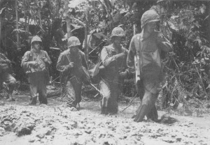 Photograph of infantry slogging through the mud