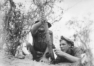 Photograph of
          Australian troops firing a 51mm mortar