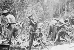 Photograph of
          British soldiers firing a 76mm mortar