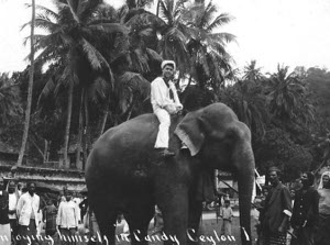Photograph of sailor riding an elephant