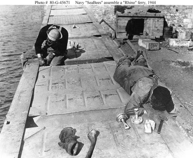 Photograph of Seabees assembling prefabricated pontoons
