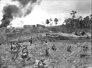Photograph of Australian troops advancing on Tarakan